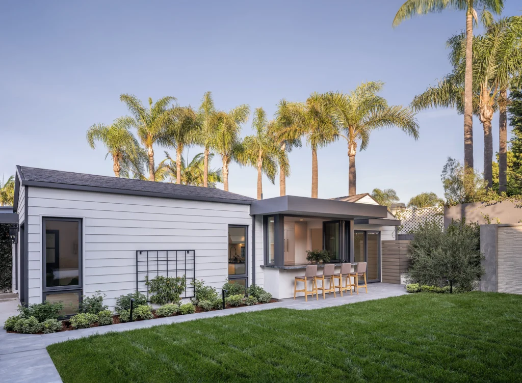 LMD Architecture ADU with window opening rom kitchen to outdoor bar space.
