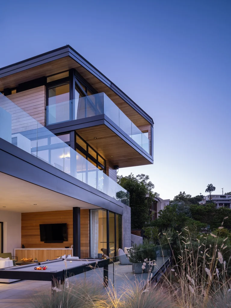 Three-story Modern home with glass balcony railing